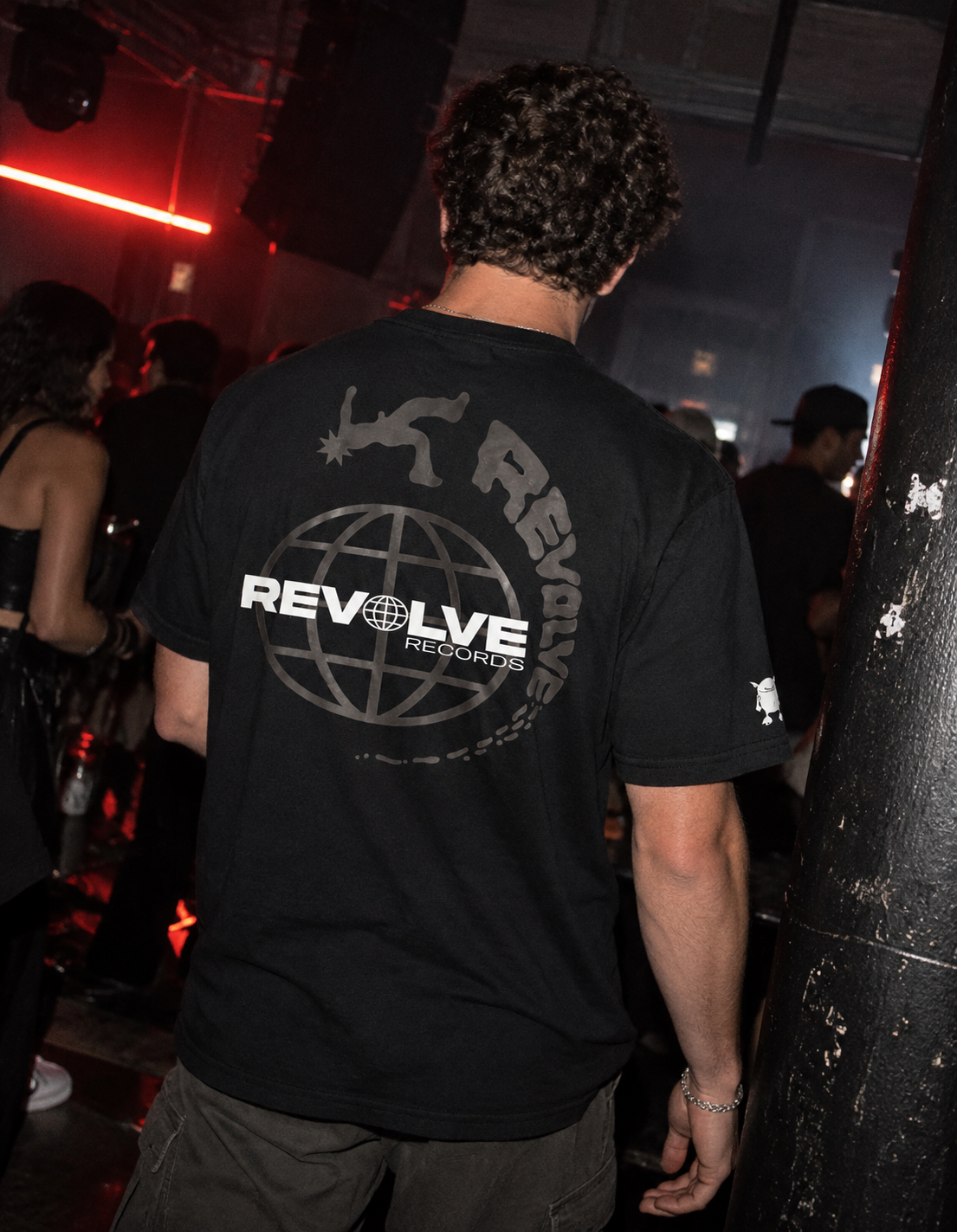 Lifestyle photograph featuring a Revolve Records shirt